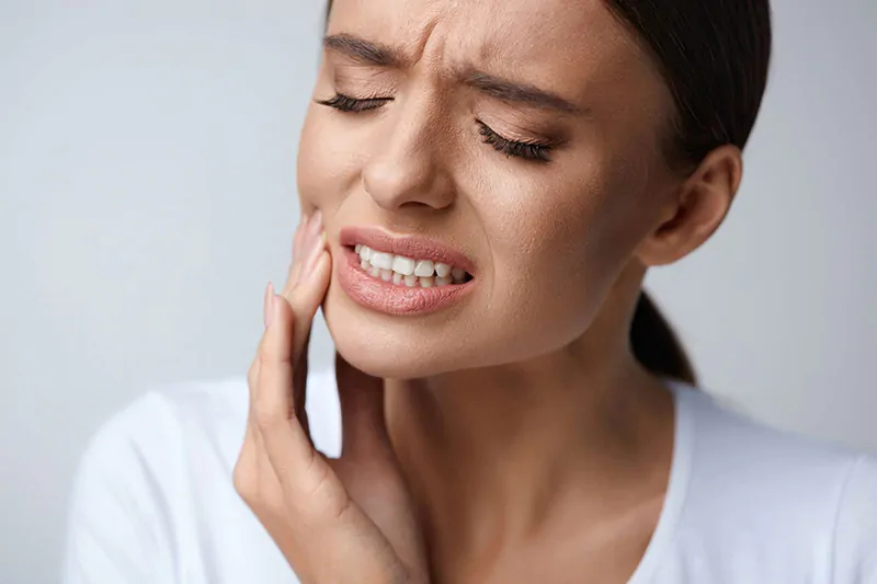 What should I do in case of a dental emergency, like a knocked-out tooth or severe toothache?